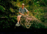 Jim sitting on boulder with plaque